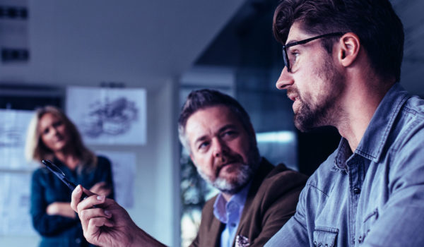Four people in a meeting discussing something seriously