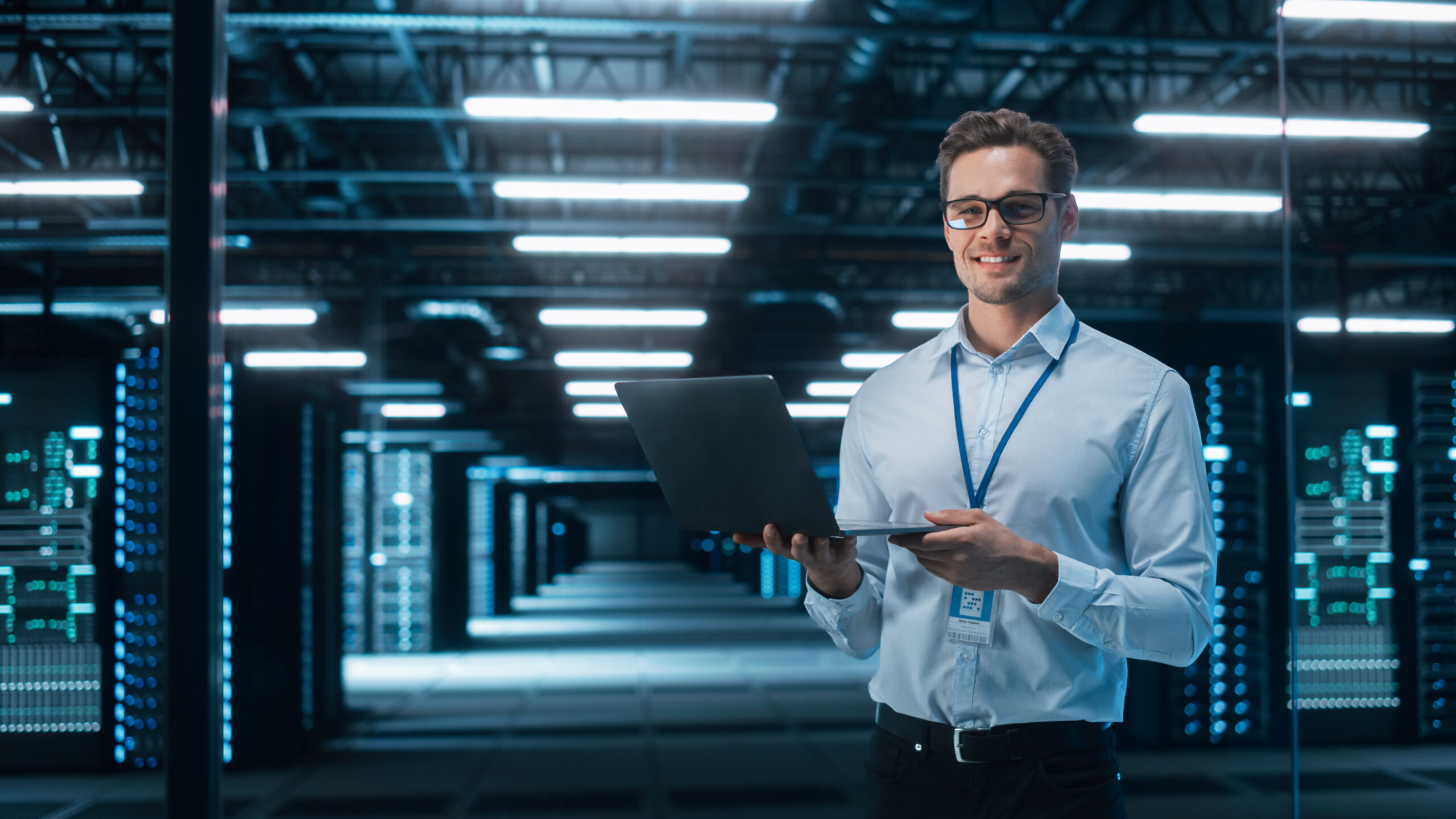 Portrait of White Male Specialist Using Laptop in Big Data Center